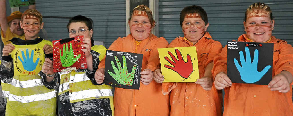 HANDS-ON: Isiah Heise, Zack Hindle, Annalyce Squires, Joe Doherty and Sarah Grimshaw try their hand at indigenous art.